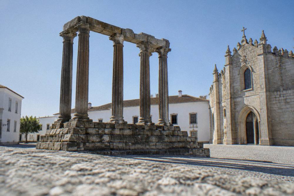 Granite columns of a Roman temple standing in an open square beside the cathedral in Évora