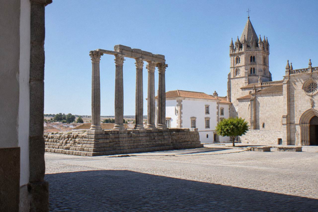 Walled historic centre of Évora with the Roman temple and cathedral tower under a clear Alentejo sky