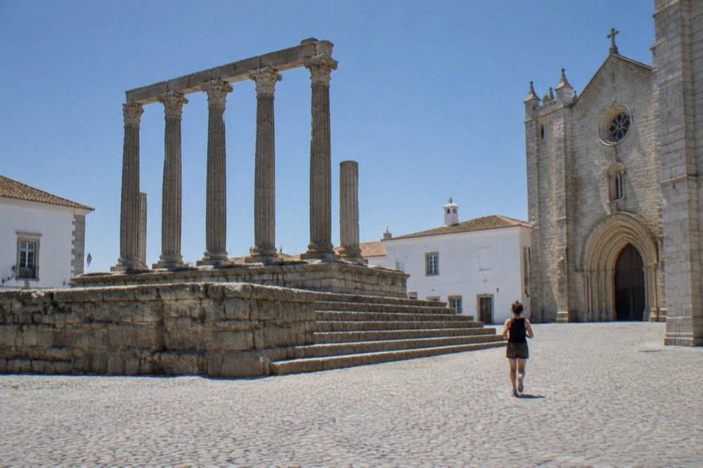 The standing columns of the Roman temple in Évora seen from the square beside the cathedral