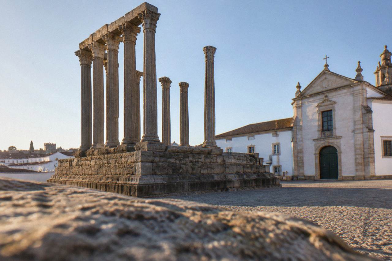 The Roman Temple of Évora rising above the rooftops of the walled historic centre