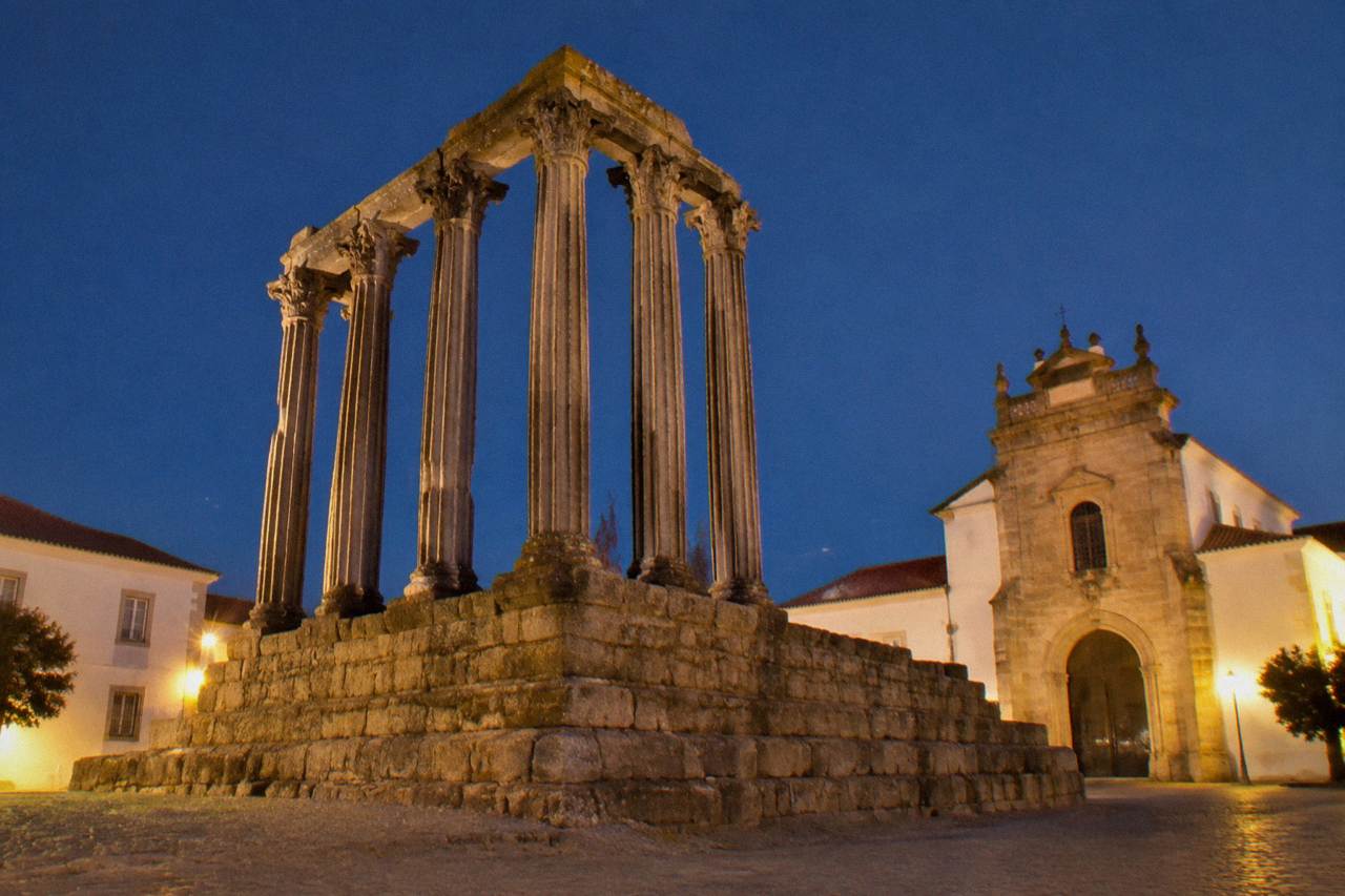 The Roman temple of Évora standing on a quiet square in the Alentejo evening light