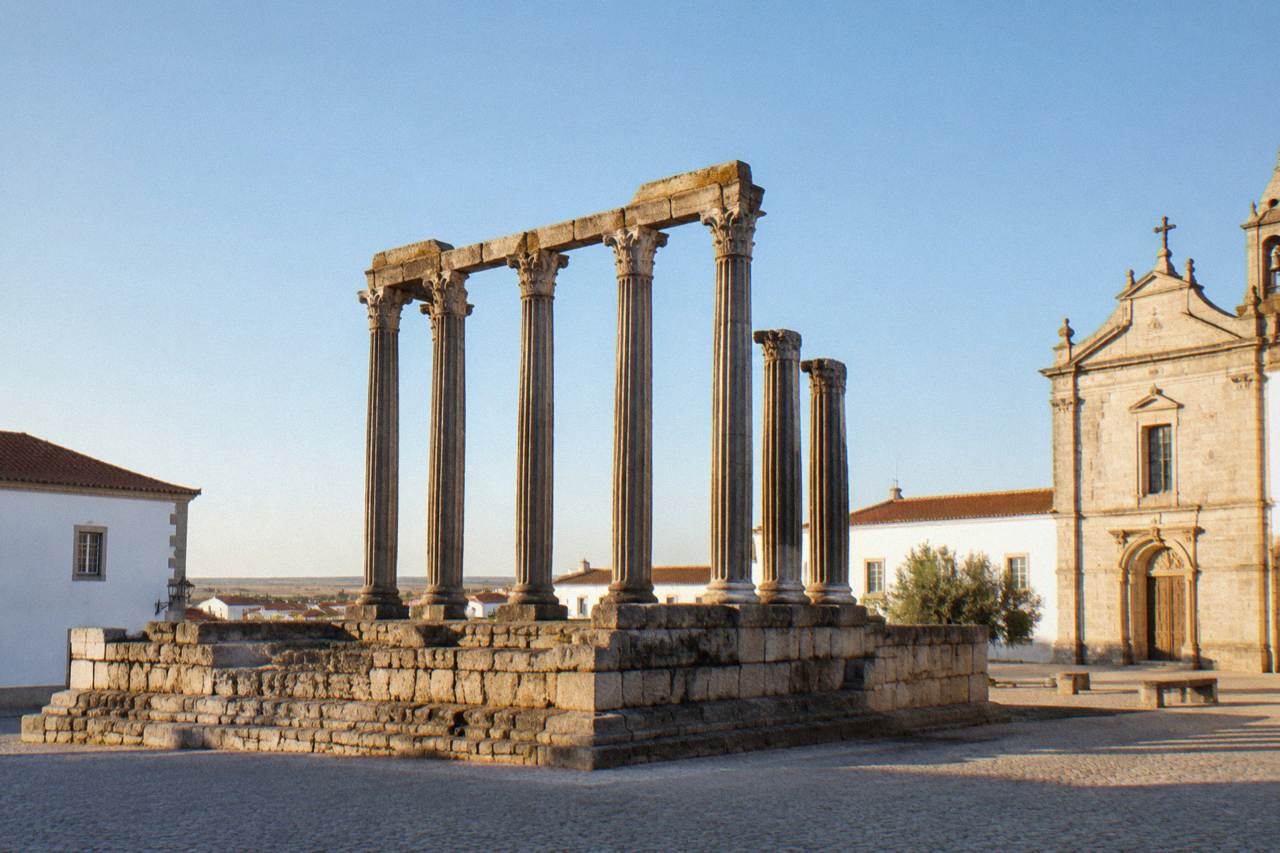 The Roman temple columns of Évora rising above a quiet square in the historic centre