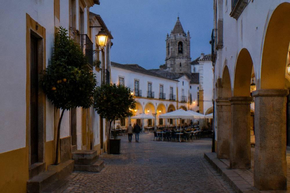 Evening light on the arcaded buildings around the main square of Évora's historic centre
