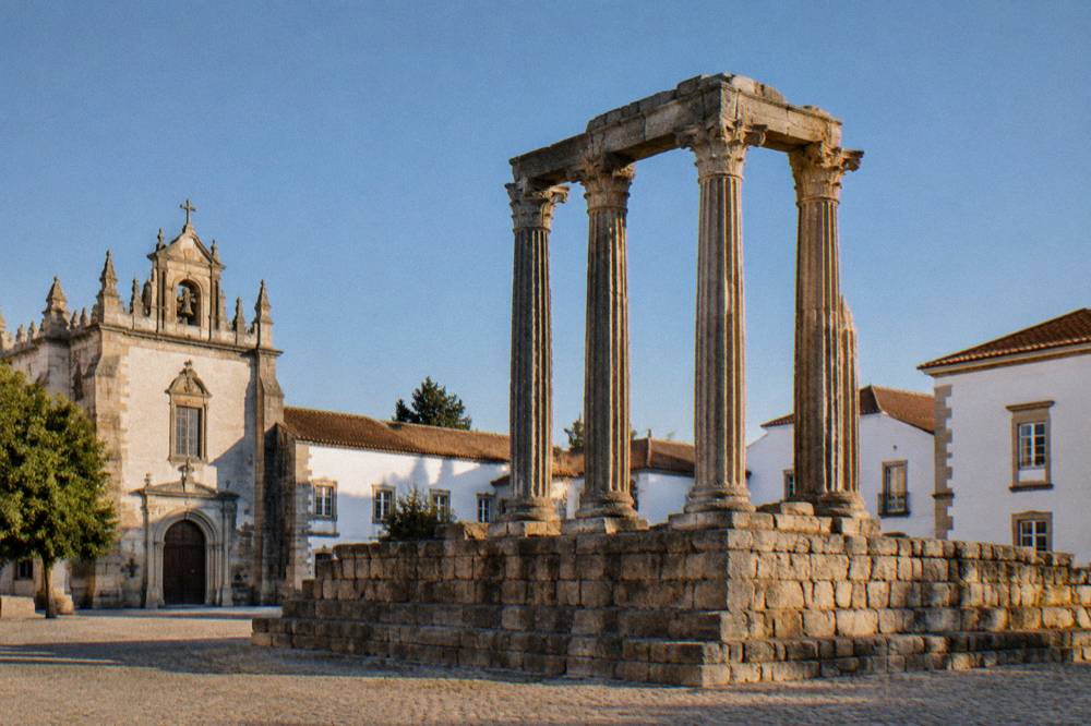 The Roman temple of Évora rising on its square in the historic centre at golden hour