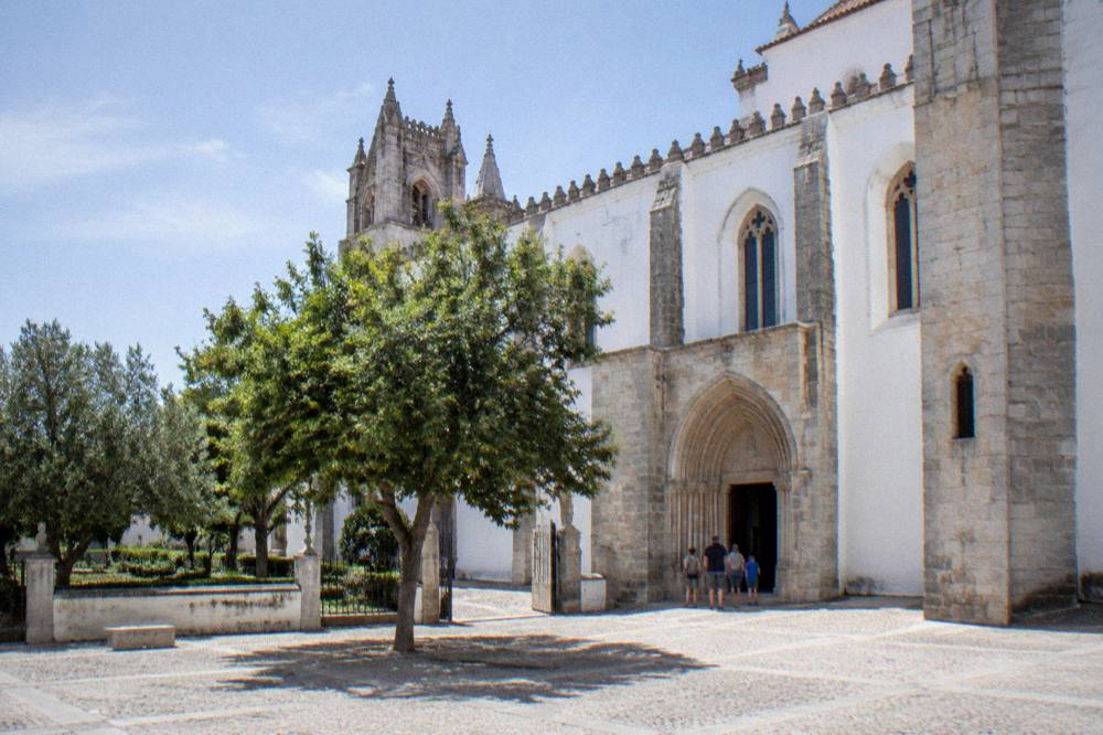 A family viewing the interior of the Chapel of Bones from its entrance area in Évora