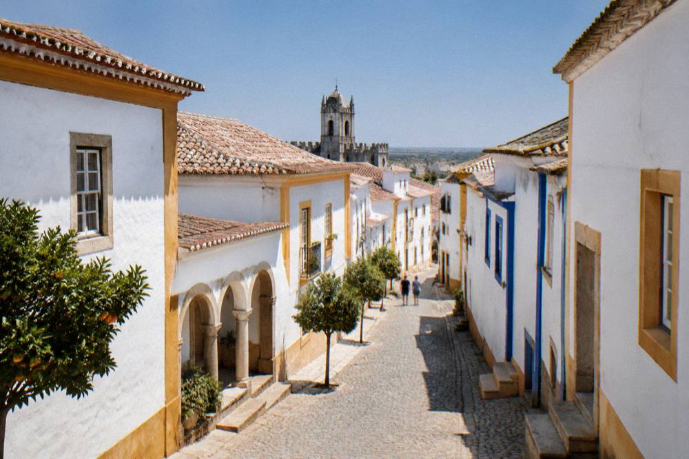 The white-walled streets of Évora's historic centre under a clear sky
