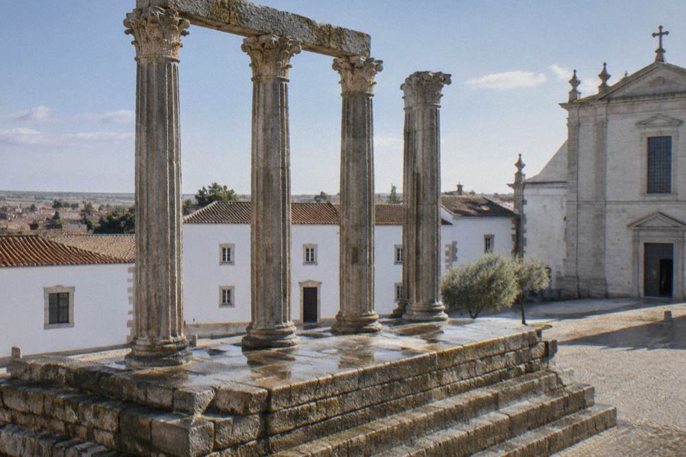 Close view of the Roman temple's stone columns and podium in Évora