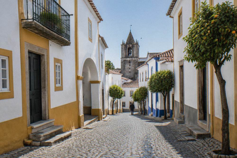 Old stone lane in central Évora with a wrought-iron balcony