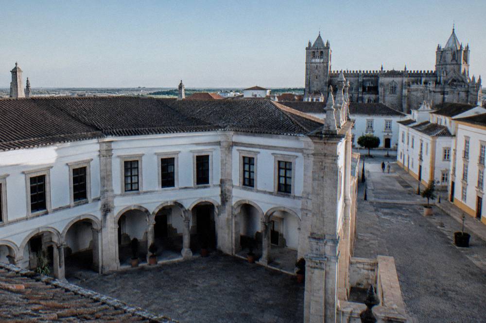 White-washed street with yellow trim and stone paving in a Portuguese town