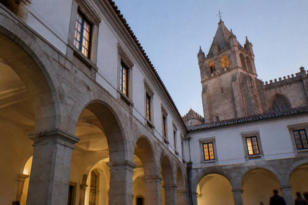 Evening light on stone buildings and a church tower in a Portuguese city