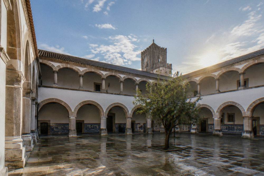 The banded schist and marble arches of the university cloister in Évora