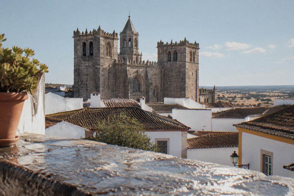Évora cathedral towers seen above rooftops from a terrace in the old city