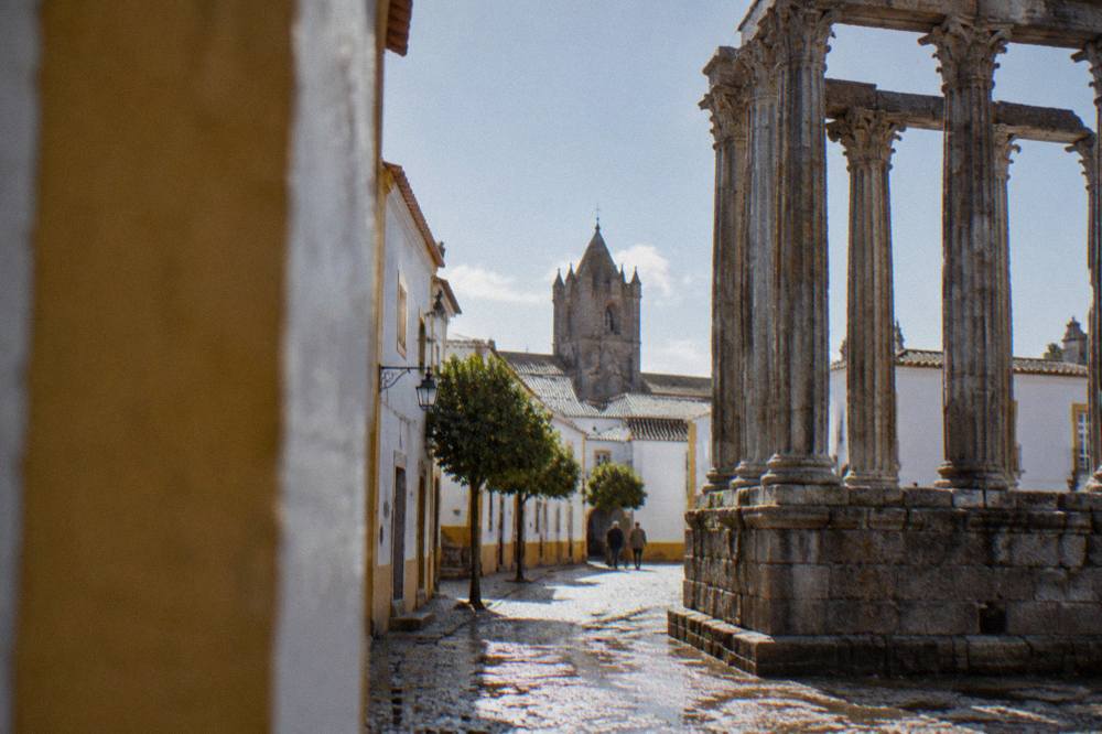 Close view of fluted granite column shafts and a Corinthian capital at the Évora temple