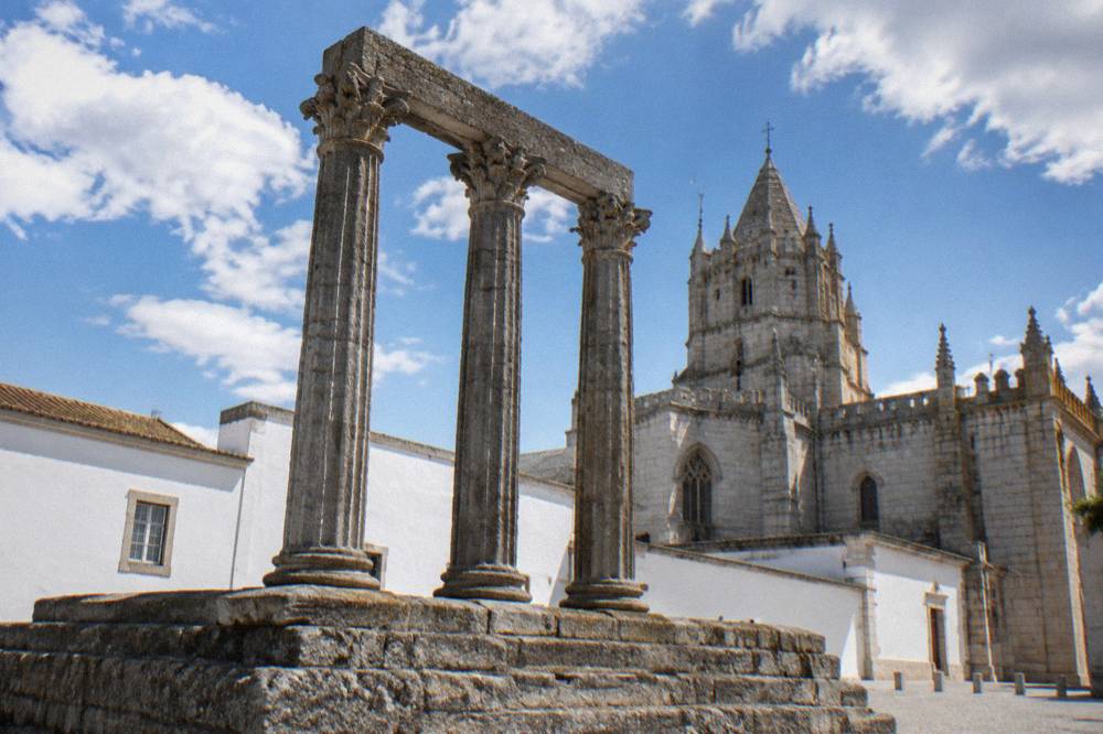 The temple columns seen from below with Évora cathedral rising behind them