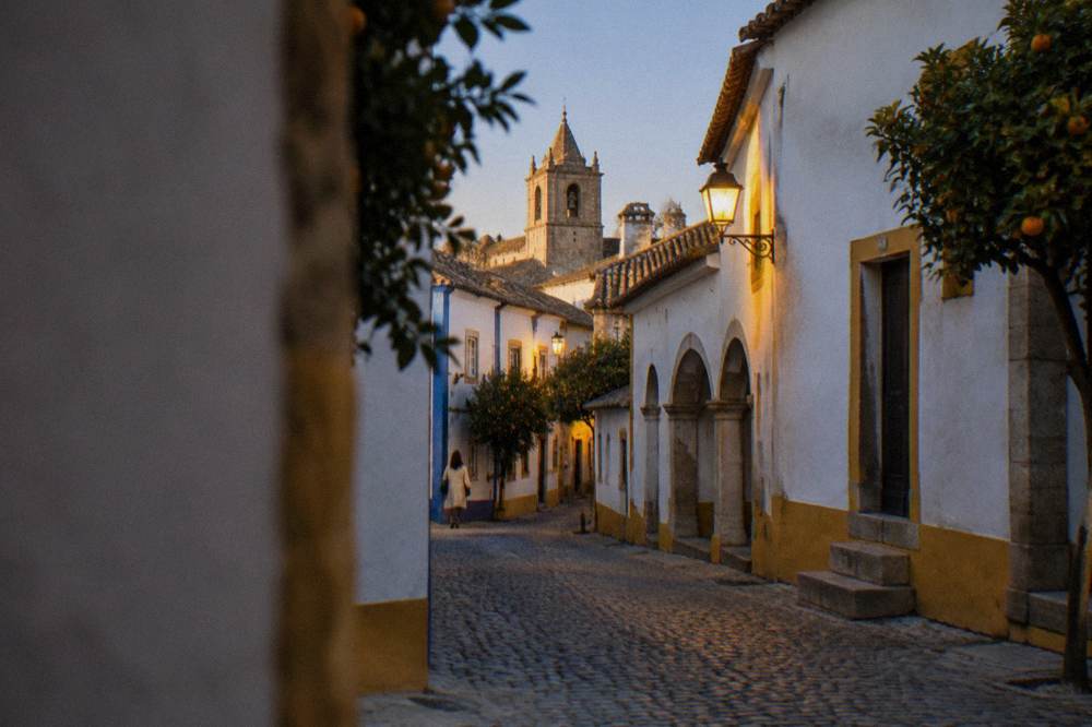 Golden evening light on the stone walls and rooftops of Évora