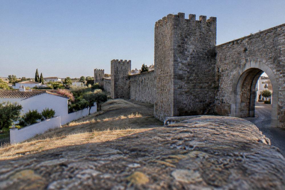 Houses and gardens seen from beside the old walls of Évora