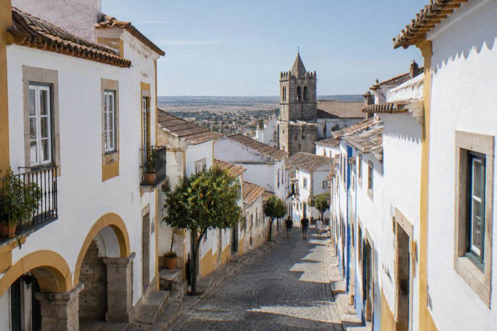 Cobbled street in Évora's historic centre leading toward the university quarter