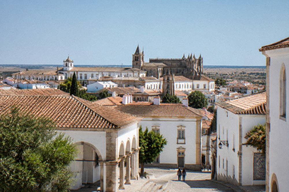 Wide view across the rooftops of Évora's historic centre with the university quarter in the middle distance
