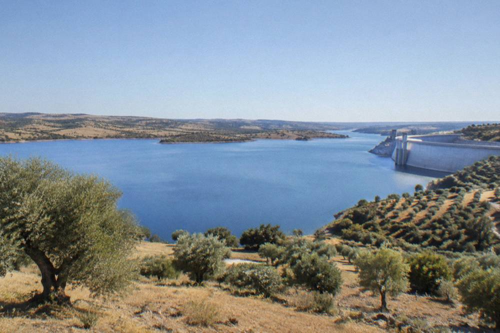 Concrete face of the Alqueva dam seen from the downstream side with the Guadiana valley beyond