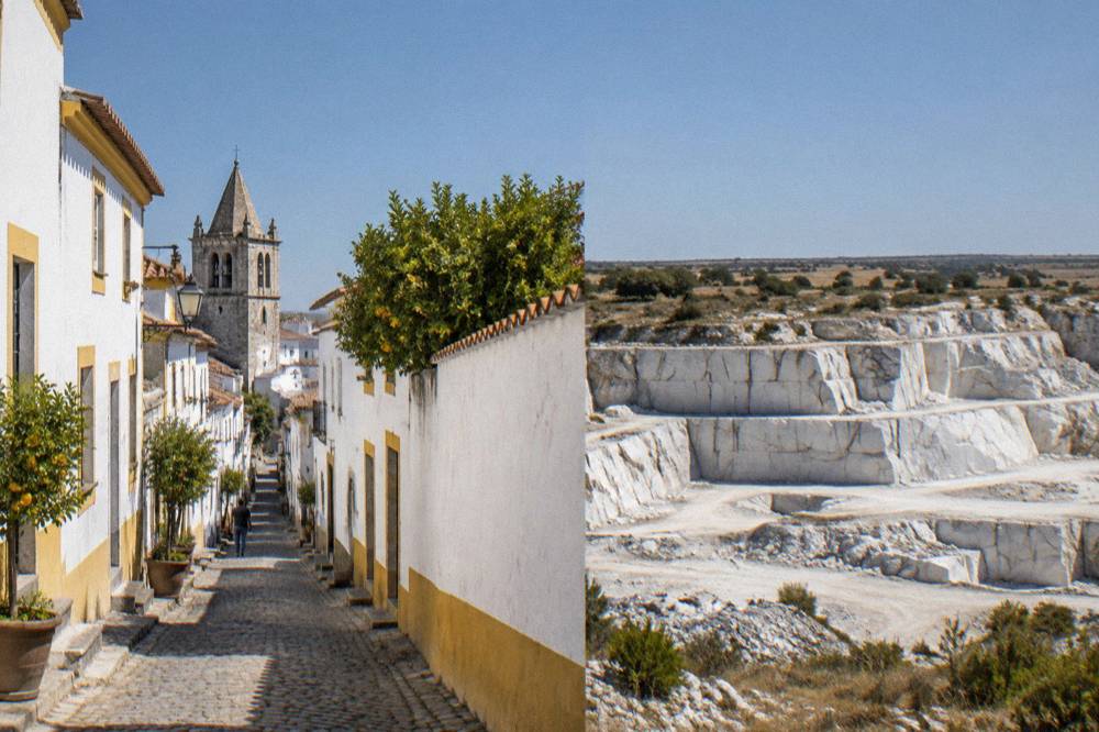 White marble quarries open like steps in the countryside near a small Alentejo town