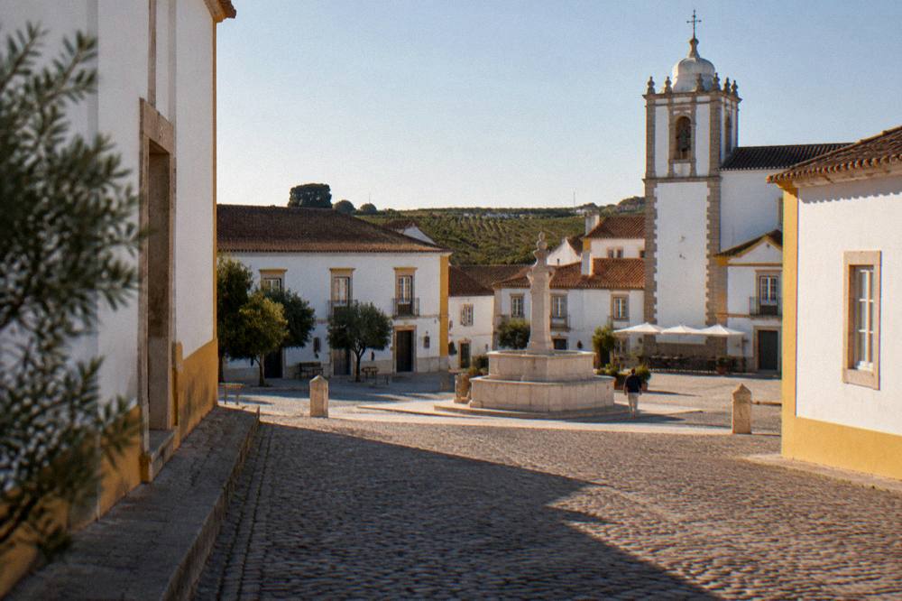 Golden late afternoon light on a stone street in a small Alentejo town
