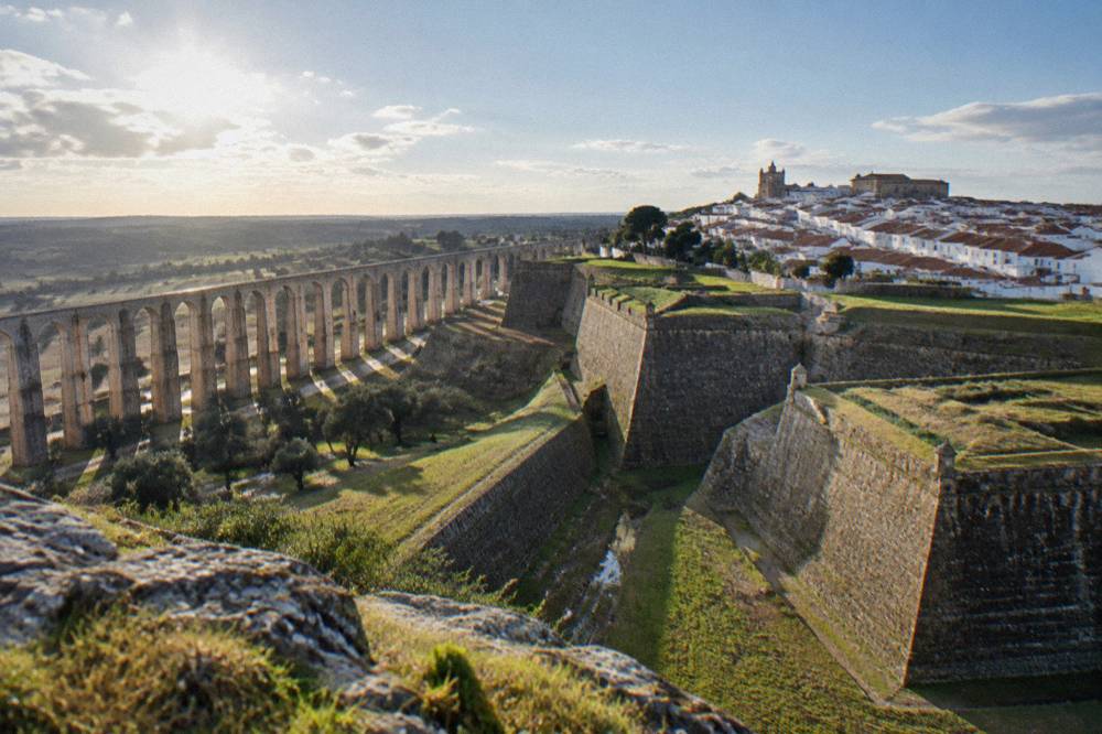 Long arcaded aqueduct of Elvas stretching across the Alentejo countryside toward the hill town