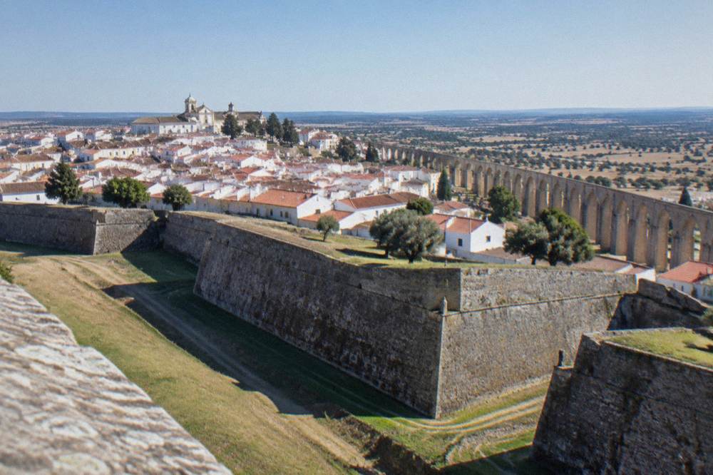 Panoramic view from Elvas walls over red rooftops toward the Spanish border countryside