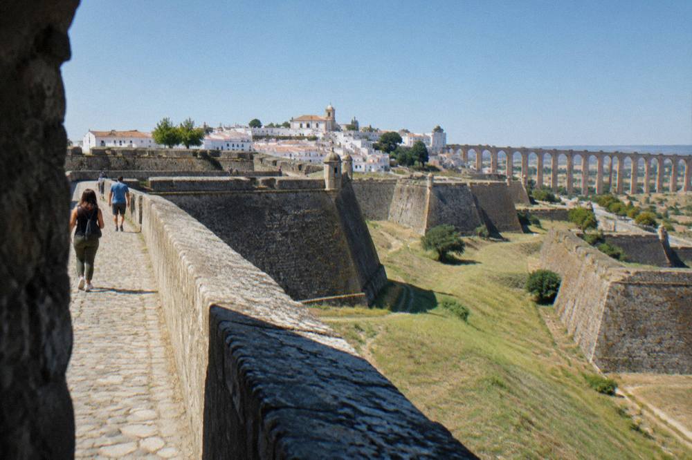 Rampart walkway of Elvas fortifications with visitors strolling between bastions