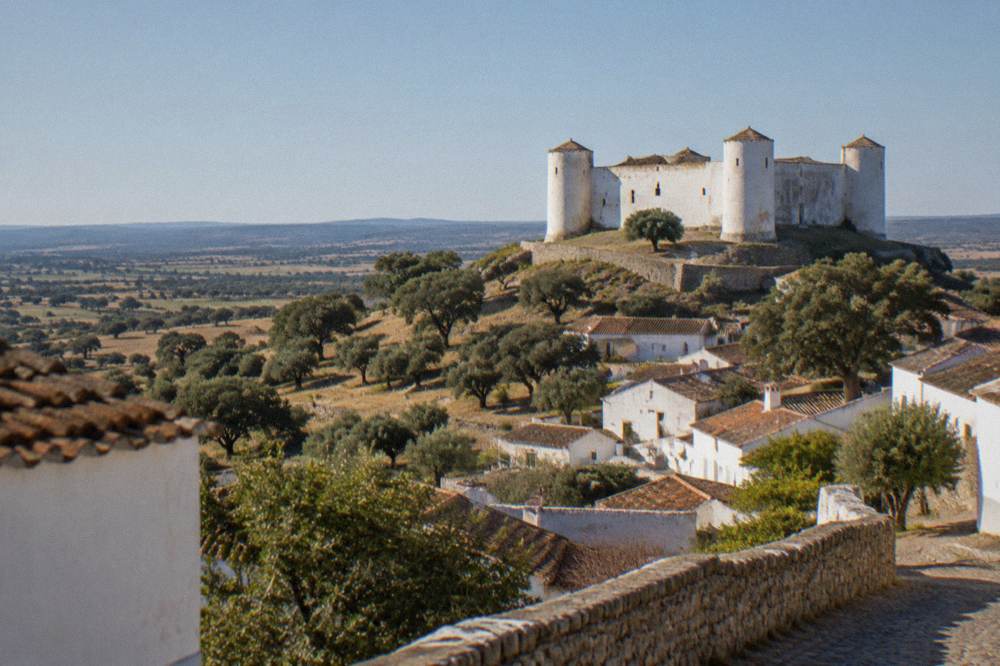 View over the Alentejo plain from the hilltop lanes of Évoramonte with cork oaks and fields