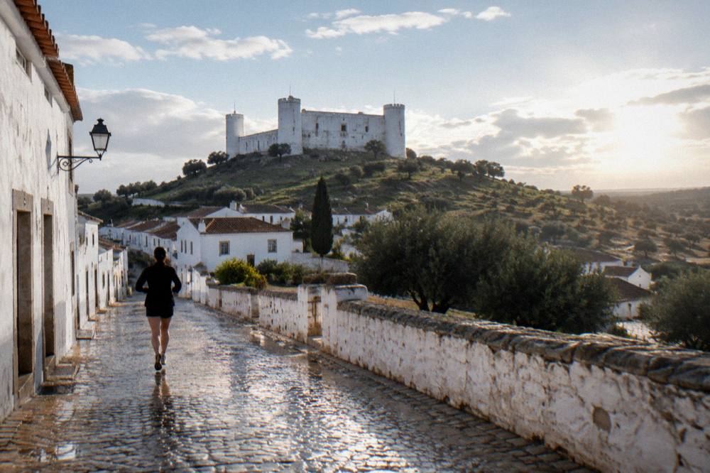White marble buildings and a castle hill in an Alentejo marble town on a bright afternoon