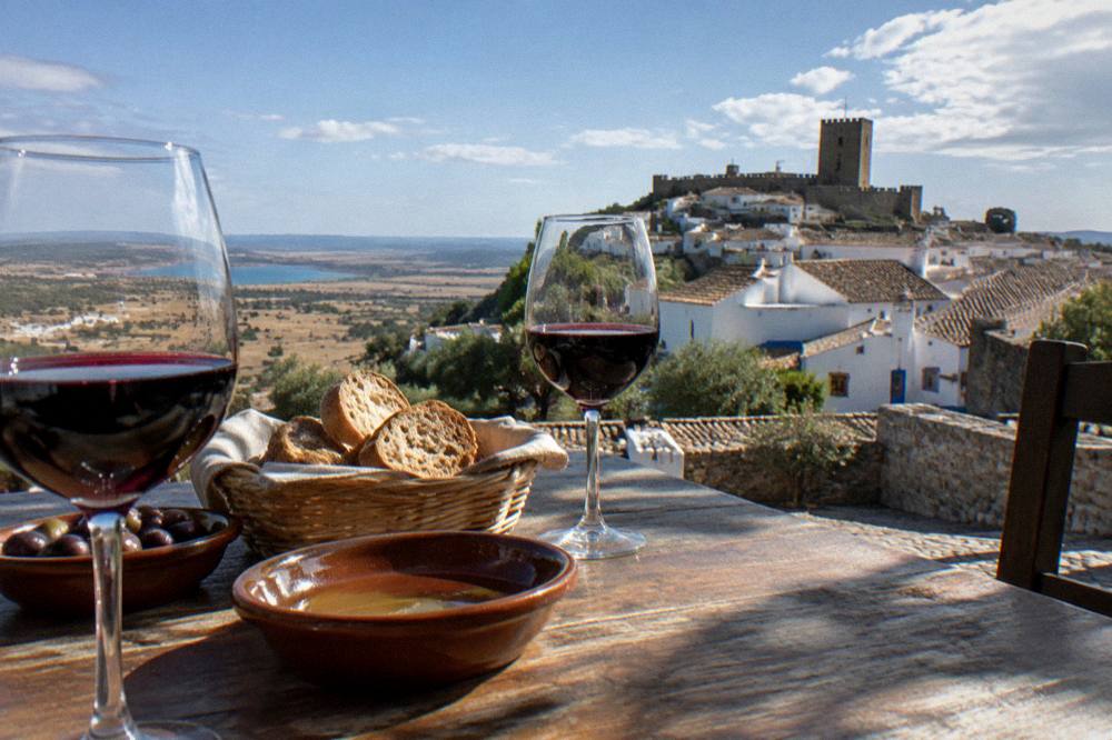 Table set with glasses of red Alentejo wine and regional bread at a winery