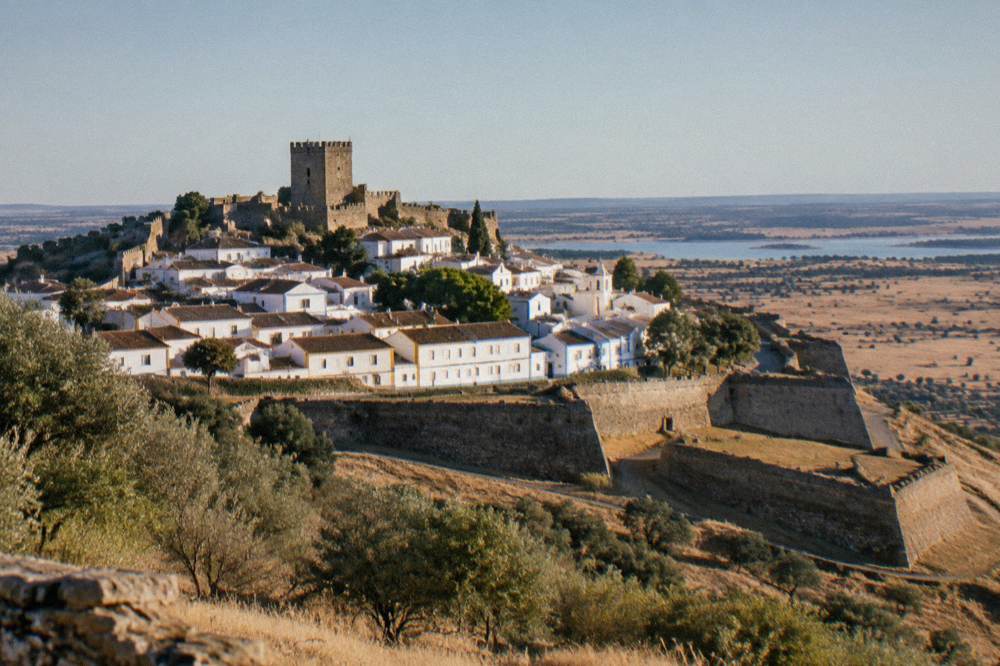 A vast star-shaped fortress wall enclosing a town on a plain under a wide sky