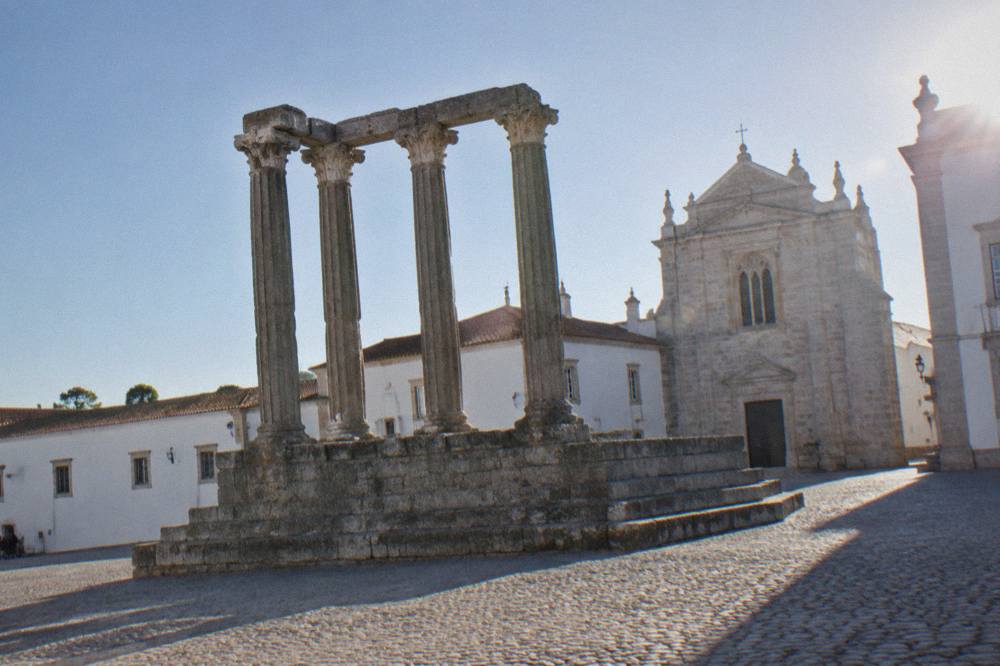 The Roman temple columns rising above the square in the centre of Évora