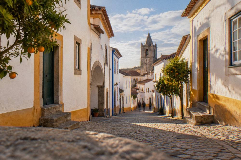 Golden late afternoon light on the whitewashed walls and terracotta roofs of Évora