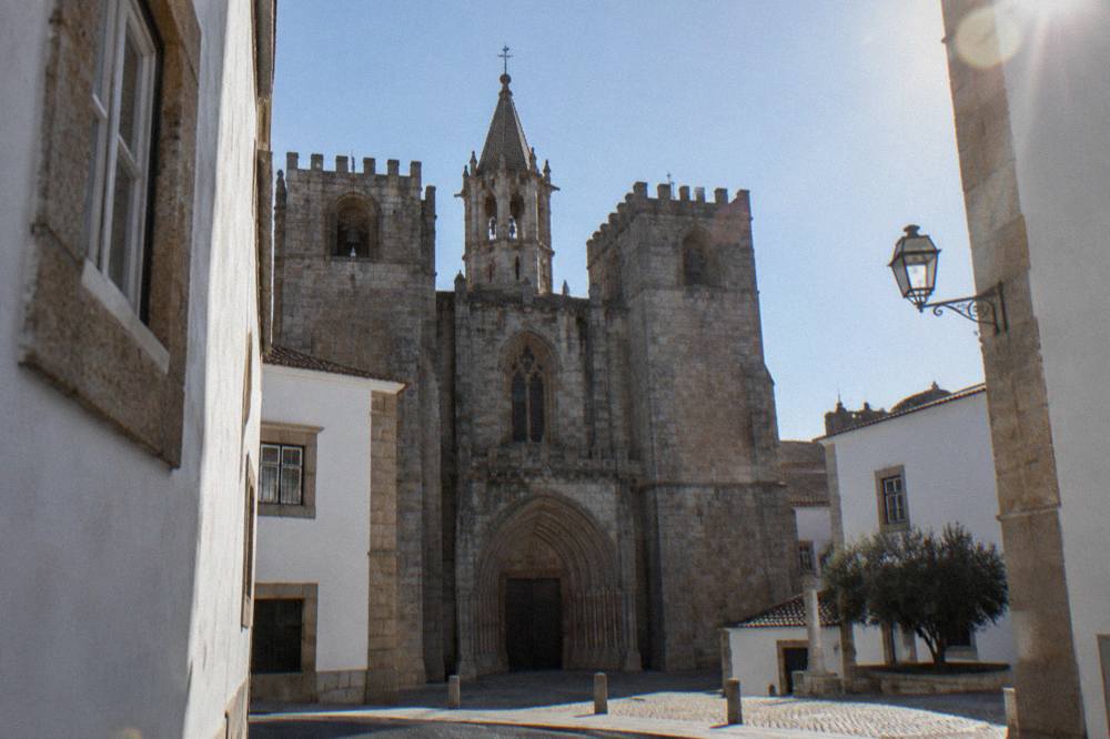 The Gothic entrance of the Sé de Évora cathedral seen from a narrow street