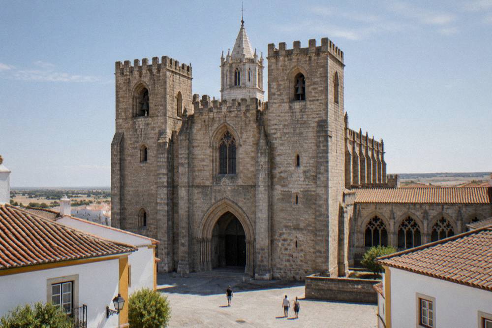 Évora cathedral cloister with Gothic arches and warm stone in afternoon light