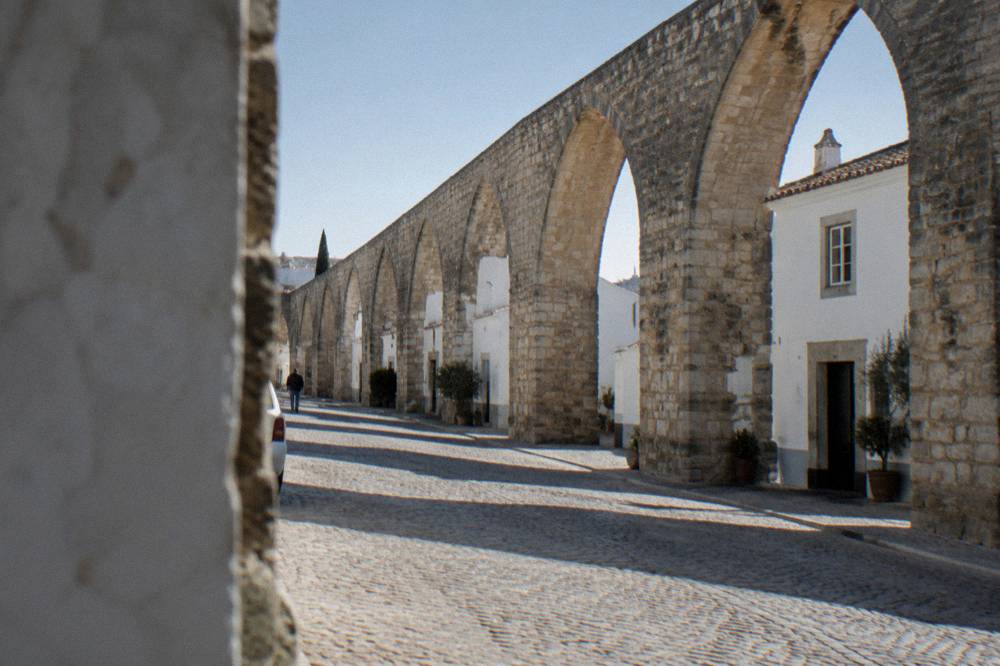 Arches of the Água de Prata aqueduct in Évora with small houses built between its stone piers