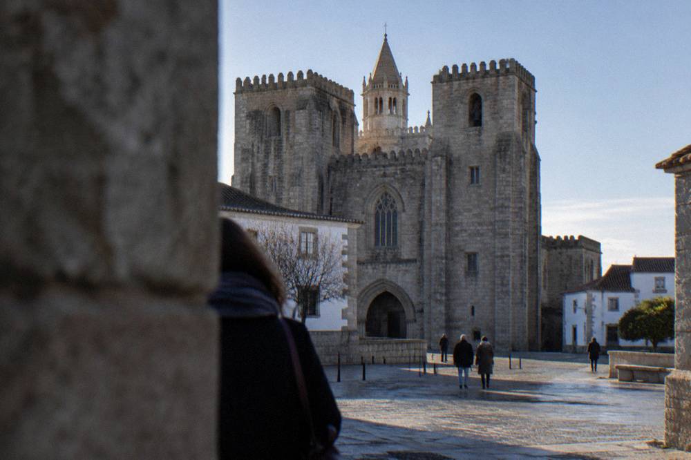 The Gothic interior of the Sé de Évora cathedral lit softly on a winter afternoon