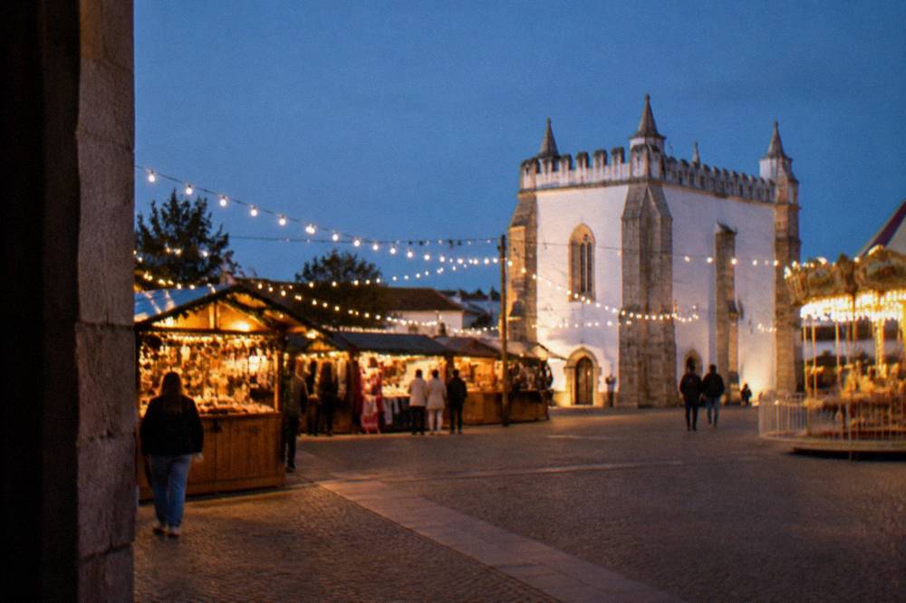 Fairground stalls and string lights on the Rossio de São Brás in Évora at night