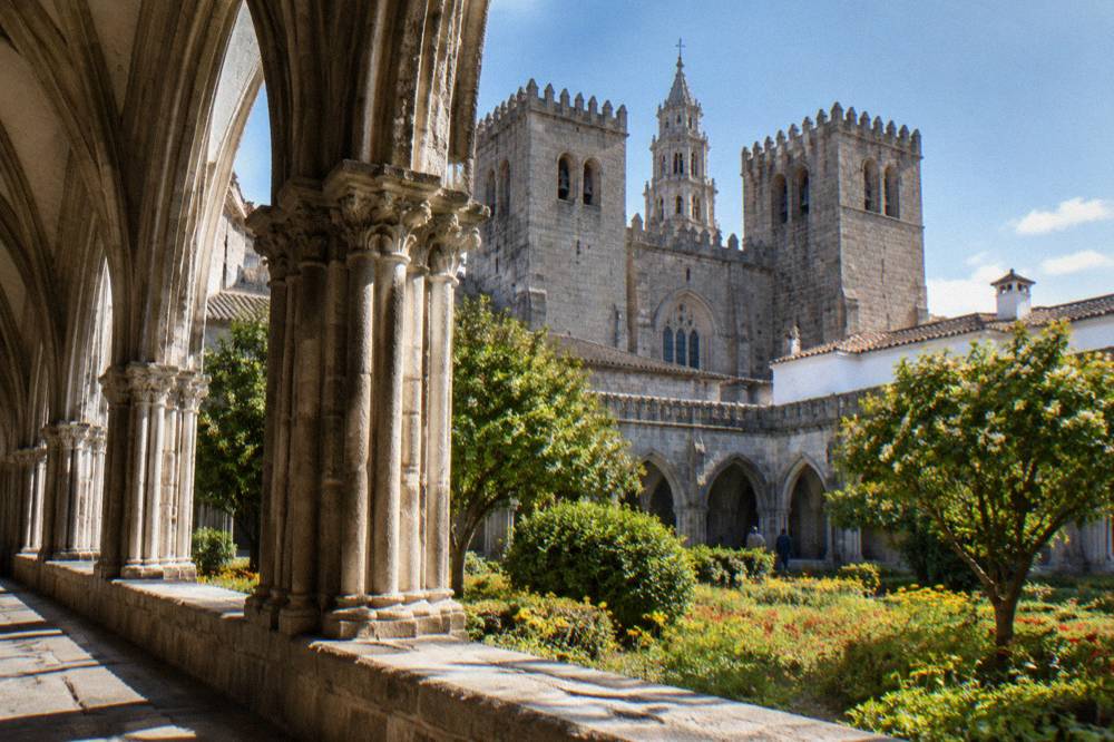 Cloister of the Sé de Évora cathedral with spring sunlight falling on the Gothic stone arches