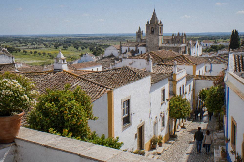 Spring evening light on the rooftops and church towers of Évora seen from a terrace inside the city walls