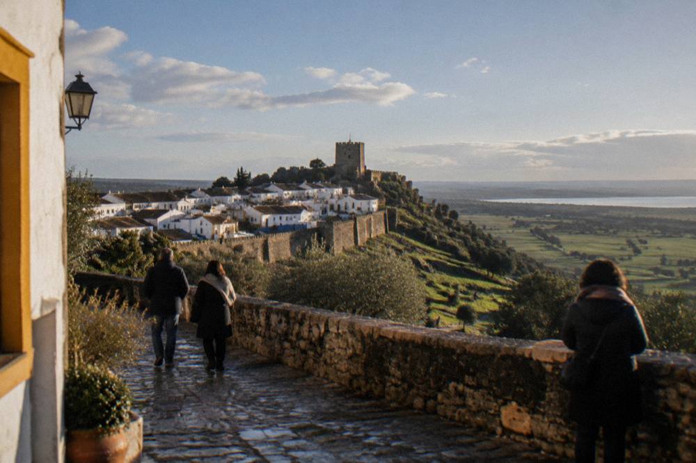 The walled hilltop town of Monsaraz seen across the Alentejo plain under a wide winter sky