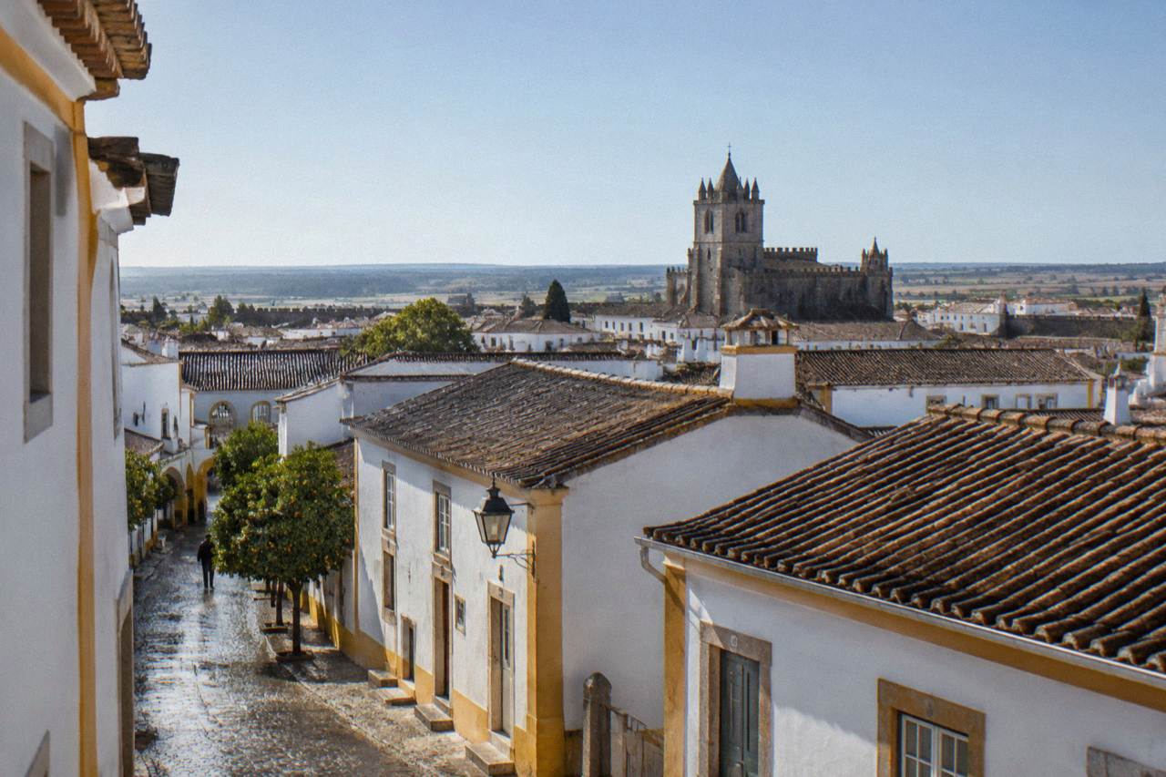 Aerial view over the rooftops of Évora with the cathedral tower rising above the old town