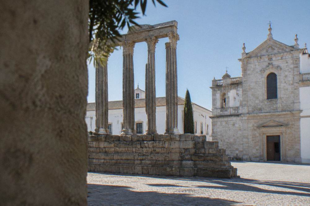 The Roman temple columns of Évora lit by late afternoon sun