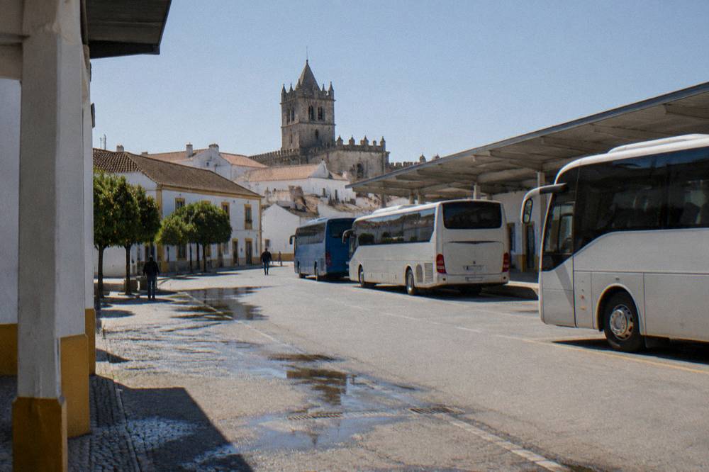 The bus terminal in Évora with regional coaches parked under a bright afternoon sky