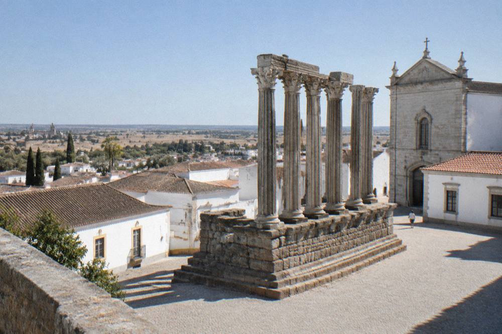 Corinthian columns of a Roman temple rising above the rooftops of Évora's old town