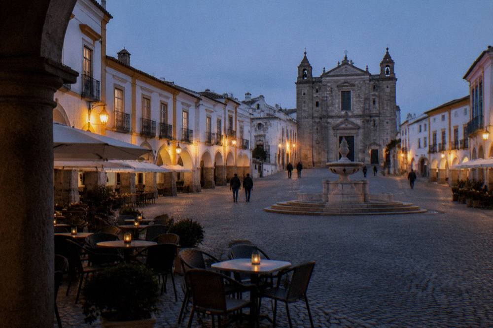 Evening light on the arcaded buildings of Praça do Giraldo, the main square of Évora