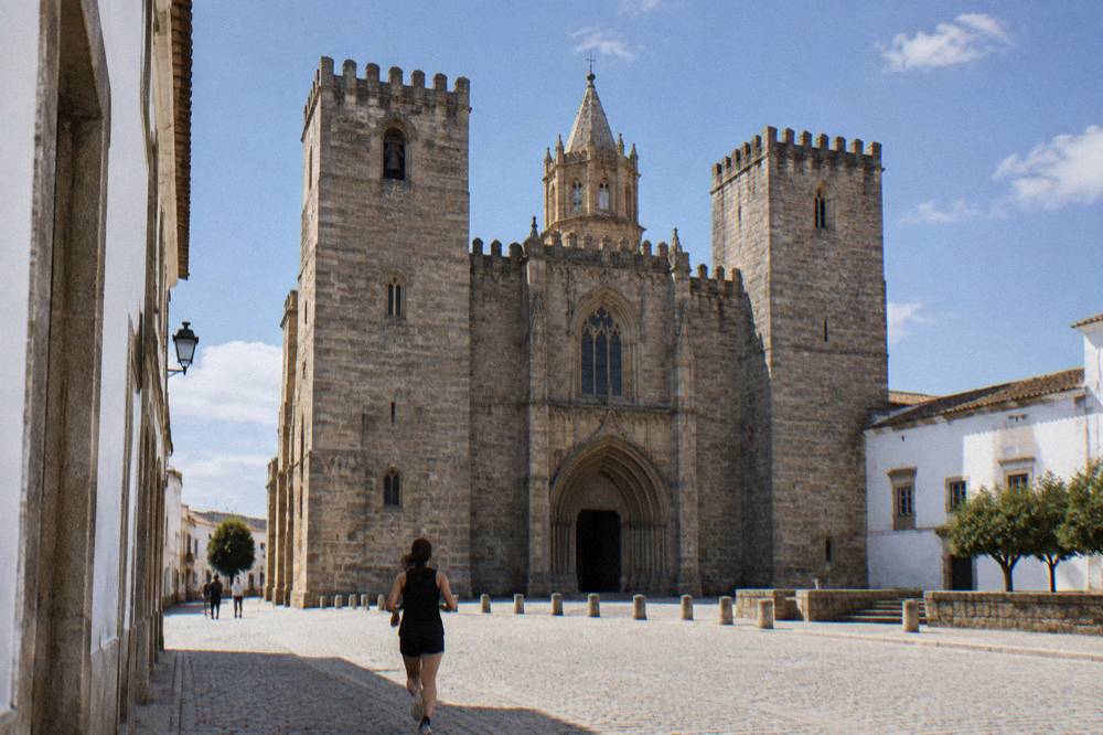 The Gothic interior of Évora cathedral with stone columns and clerestory windows