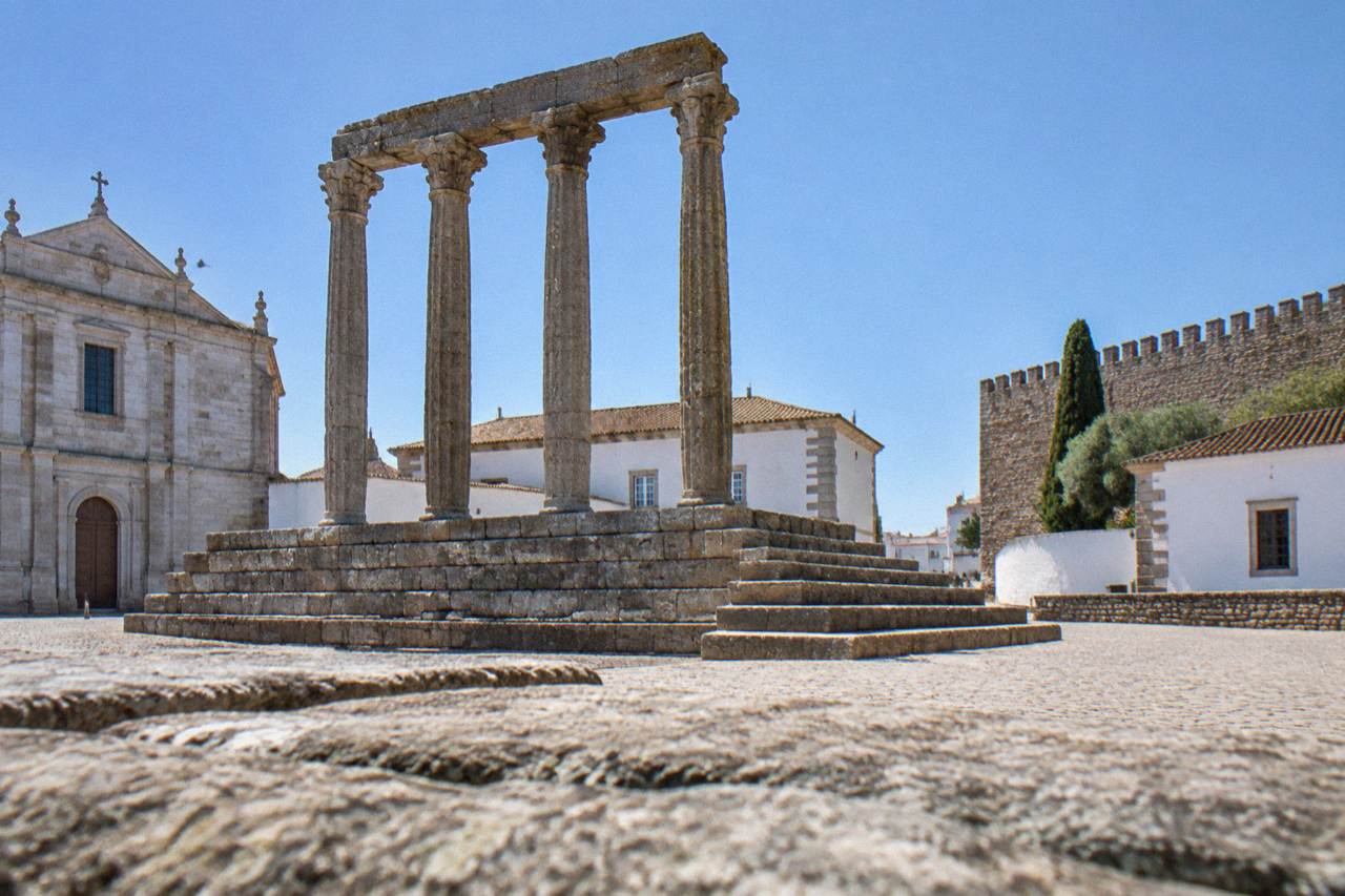 The Roman temple and medieval walls of Évora under a clear Alentejo sky