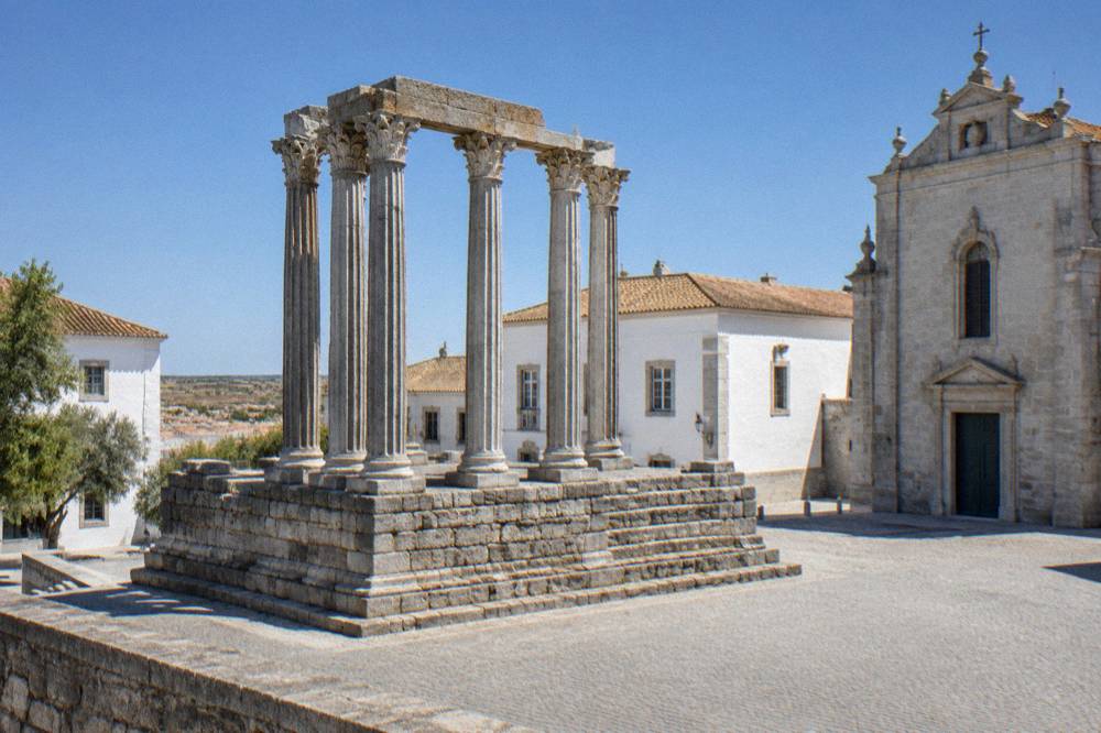 The granite Roman temple of Évora with Corinthian columns standing between later buildings